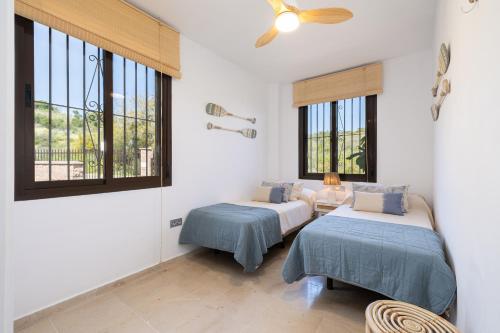 a bedroom with two beds and a window at Apartment with Private Terrace Calanova Golf by AORA STAY in Mijas Costa