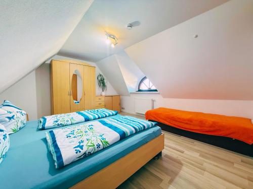 two beds in a bedroom with an attic at Ferienwohnung 2 Wald & See in Zirchow