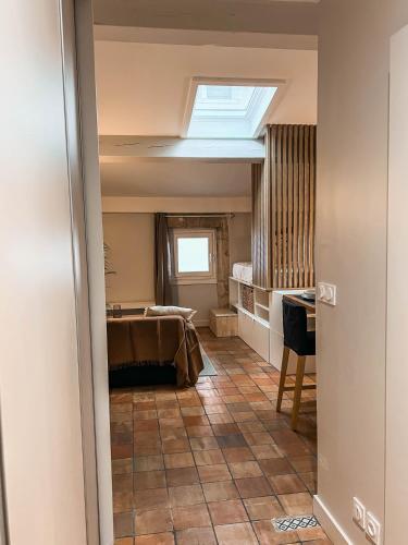 a room with a bed and a skylight at Studio cosy Villefranche-Sur-Saône in Villefranche-sur-Saône