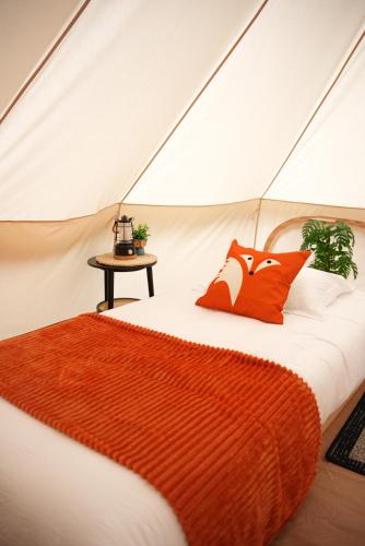 a bedroom with a bed in a tent at Grotto Getaway in Miller Lake