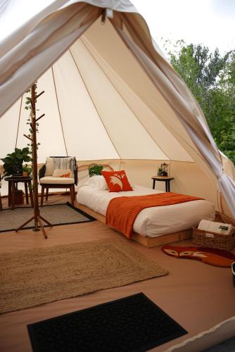 a bedroom with a bed in a tent at Grotto Getaway in Miller Lake