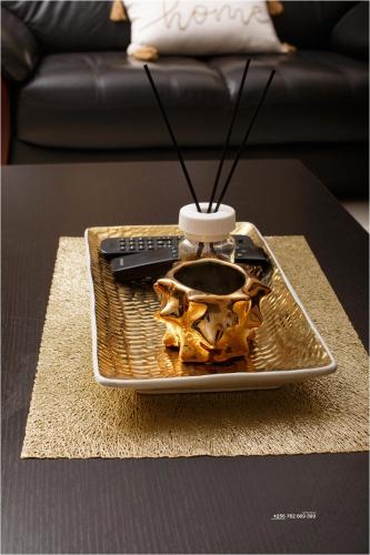 a tray with a remote control on top of a table at Rukundo's Residence in Nalakonge