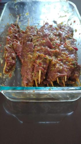 a glass dish filled with meat and sauce at Quinta Divina Providencia in Fusagasuga