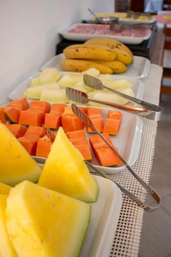 a tray of fruits and vegetables on a table at Pousada Margerie Ubatuba - Ítagua in Ubatuba