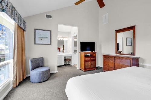 a bedroom with a bed and a dresser and a television at The Links in Myrtle Beach