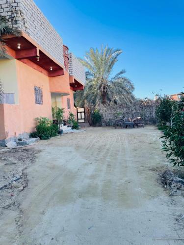 a dirt road in front of a house at Mo'men Home in Siwa