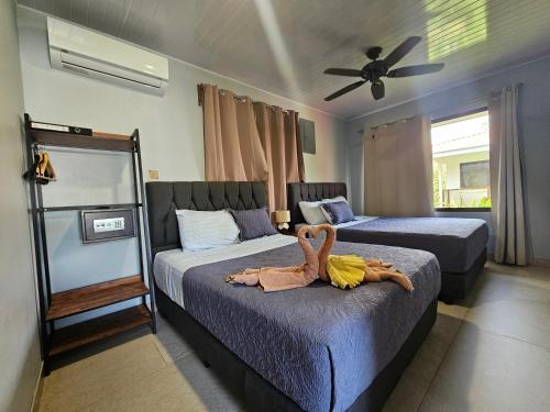 a bedroom with two beds with a stuffed animal on the bed at Ballena Rey Hotel in Uvita
