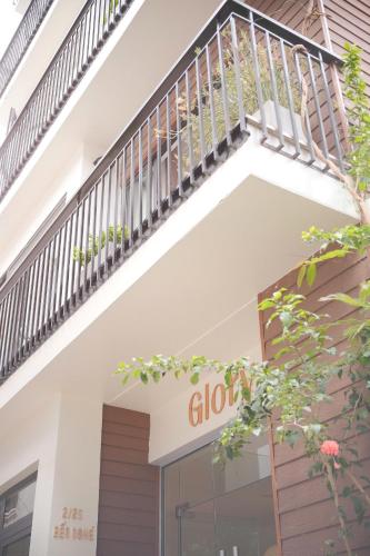 a staircase above a store window with a sign that reads glory at Glory 2 Hue Homestay in Hue