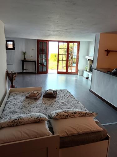 a bedroom with a large bed with two towels on it at Pian delle Betulle in Torri del Benaco