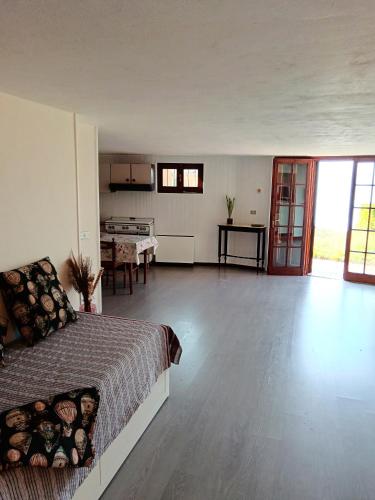 a bedroom with a bed and a kitchen and a table at Pian delle Betulle in Torri del Benaco