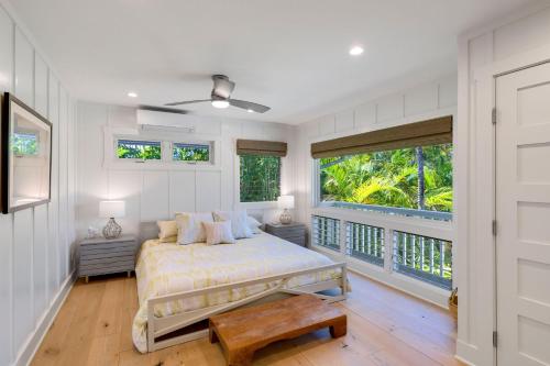 a bedroom with a bed and a balcony at Camp Magic 2 in Hanalei