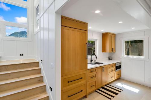 a kitchen with wooden cabinets and a sink at Camp Magic 2 in Hanalei