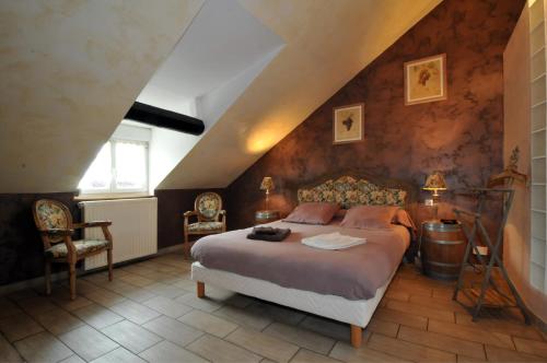 מיטה או מיטות בחדר ב-Gite de la Loge