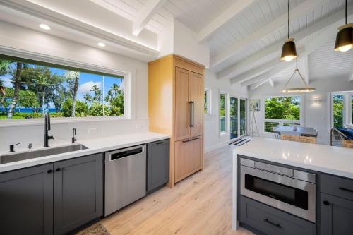 a kitchen with a large sink and a large window at Camp Magic 1 in Hanalei