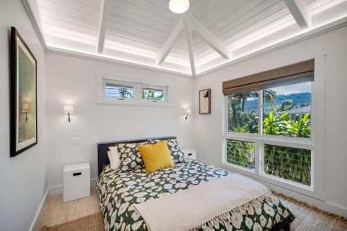 a bedroom with a bed and a large window at Camp Magic 1 in Hanalei