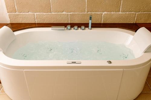 a white bath tub in a bathroom at Talassa - Dimora di Charme Suite con vasca idromassaggio in Taranto