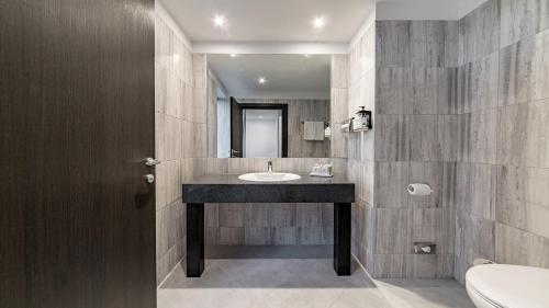 a bathroom with a sink and a mirror at Holiday Inn Bucharest - Times by IHG in Bucharest