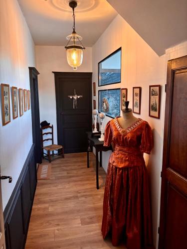 a dress on a mannequin in a hallway at La Tannerie de Montreuil in Montreuil-sur-Mer