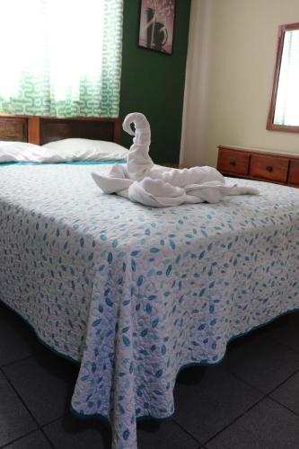 a swan is sitting on top of a bed at Hotel Toledo in David