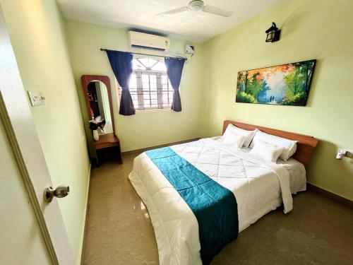 a bedroom with a bed and a window at Sapnahomes 2BHK near famous Colva beach in Colva