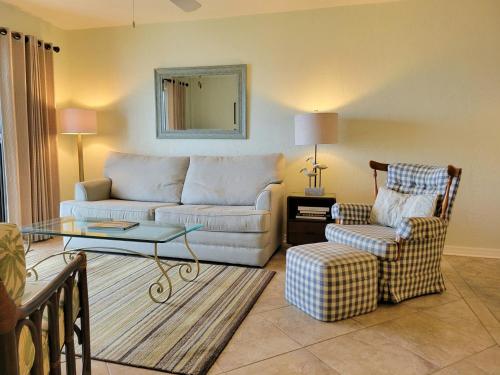 a living room with a couch and a chair at 408 - Very nice 2 bedroom ocean view in New Smyrna Beach
