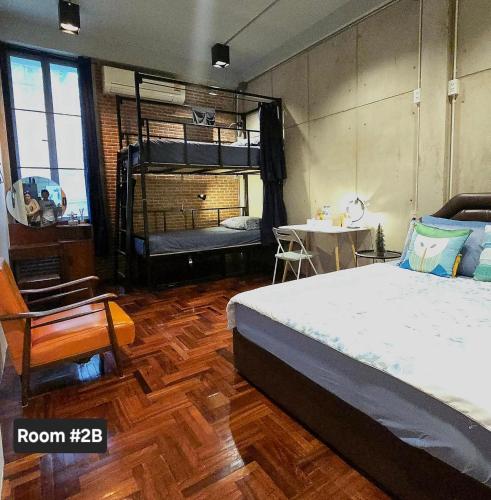 a bedroom with a bed and a table with a tableablish at MEEMAW'S House Hostel in Bangkok