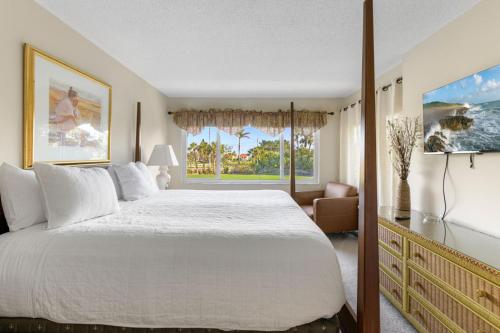 a bedroom with a large bed and a window at Charming 2-Bedroom, 2-Bath Condo with Golf Course Views in Isla Del Sol in Point Brittany