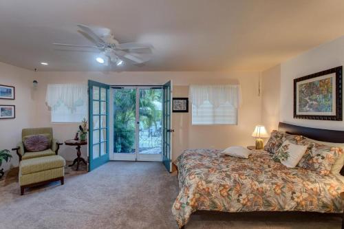 a bedroom with a bed and a ceiling fan at Hale O Makani in Keaau