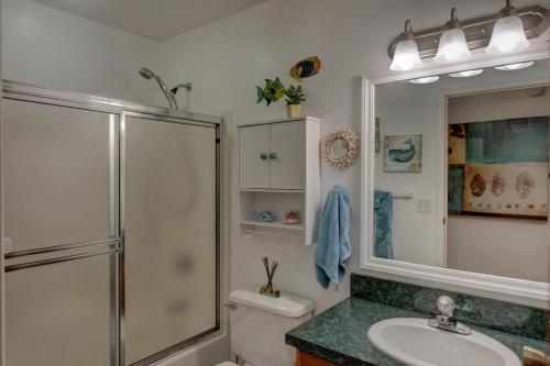 a bathroom with a shower and a toilet and a sink at Hale O Makani in Keaau