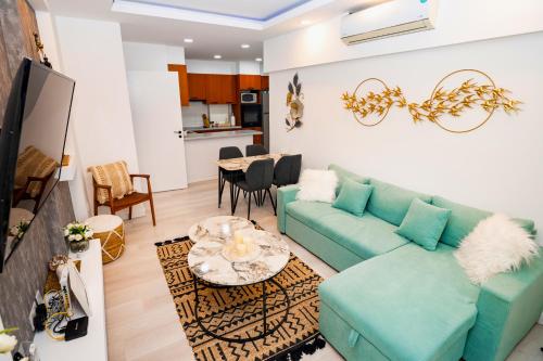 een woonkamer met een bank en een tafel bij Lazuli Sea View Beachfront Ap 21 in Larnaka