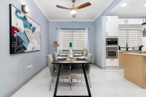 a kitchen and dining room with a table and chairs at Coastal Escape in Riviera Tower Isle Beach Neaby in St Mary