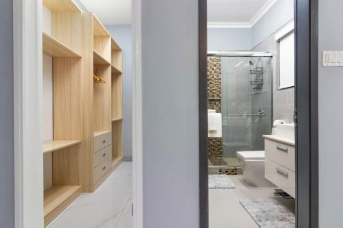 a bathroom with a shower and a toilet and a sink at Coastal Escape in Riviera Tower Isle Beach Neaby in St Mary