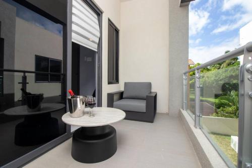 a balcony with a table and a chair on a balcony at Coastal Escape in Riviera Tower Isle Beach Neaby in St Mary