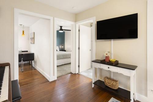 a living room with a television on a wall at 4 bedroom Private House in central Chico in Chico