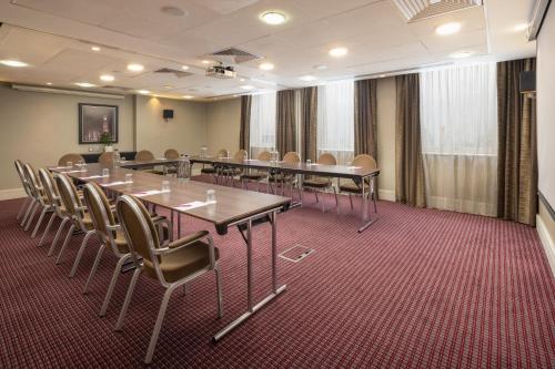 a conference room with a long table and chairs at Crowne Plaza London Ealing by IHG in London