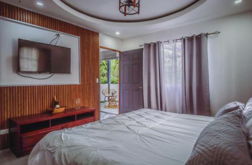 a bedroom with a bed and a tv on the wall at Deluxe beach house in Westfalia
