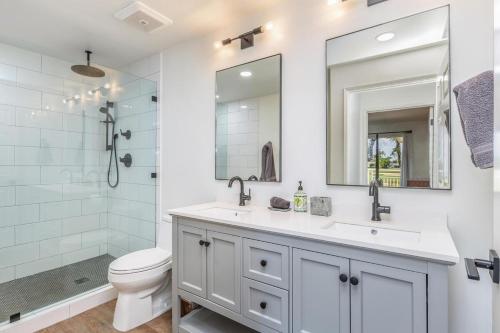 a bathroom with a sink and a toilet and a shower at Emmalani Court 322 in Princeville