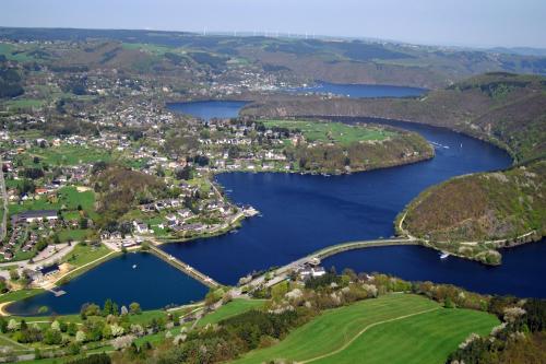 an aerial view of a town and a lake at Garni Hotel Henn in Simmerath