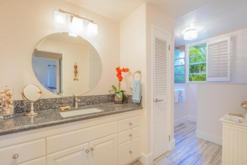 a bathroom with a sink and a mirror at Hale Emmalani #311 in Princeville