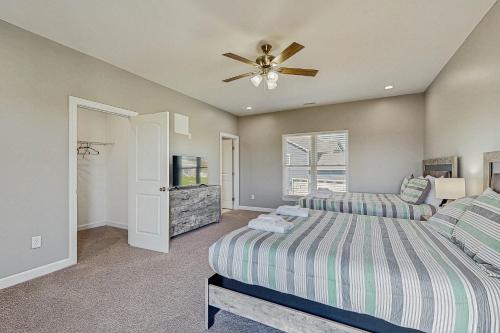 a bedroom with two beds and a ceiling fan at Sunset Valley in Kirk O'Cliff