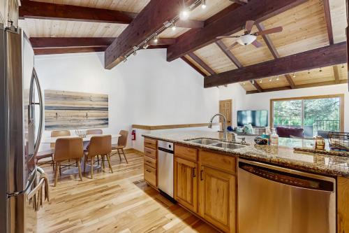 a kitchen with wooden cabinets and a table with chairs at Retreat at Oriole Way in Incline Village
