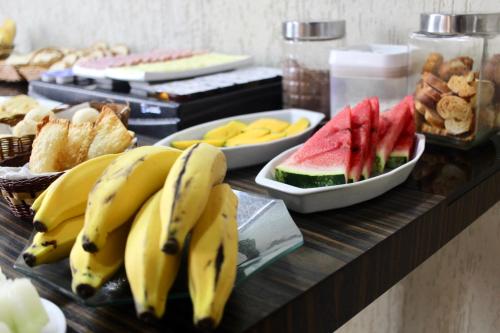 a buffet with bananas and watermelons and other foods at Atobás in Arraial do Cabo