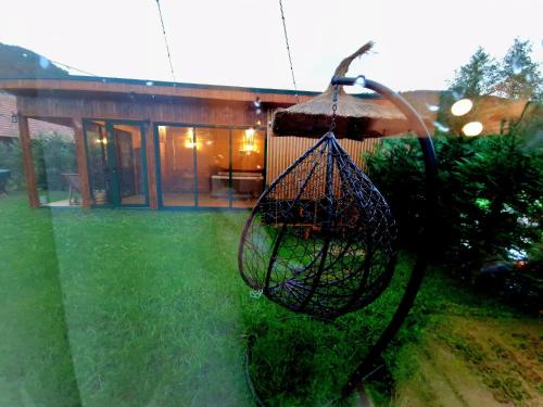 a bird cage hanging from a house at Noor House 1 in Şuncuiuş