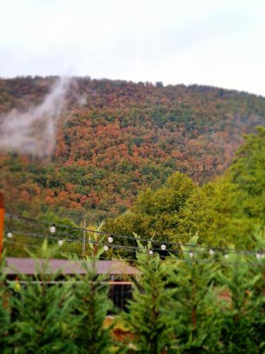 a mountain with a waterfall on top of it at Noor House 1 in Şuncuiuş