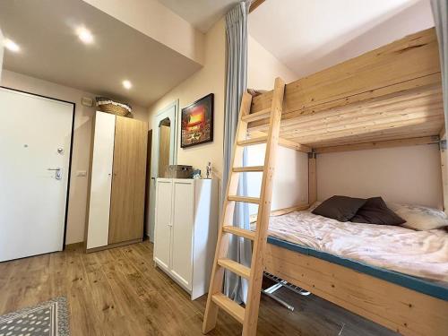 a bedroom with a bunk bed and a ladder at Sogno di Riviera in Sanremo