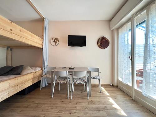 a room with a table and chairs and a bed at Sogno di Riviera in Sanremo