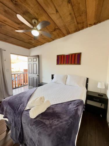 a bedroom with a large bed with a wooden ceiling at Sonnenhaus Antigua in Antigua Guatemala