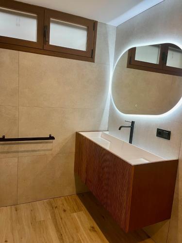 a bathroom with a sink and a mirror at Apartamentos HORNOS in Hornos