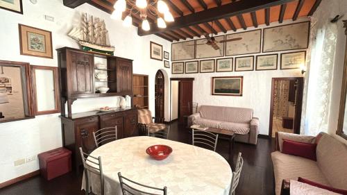 a living room with a table and chairs and a couch at Casa Franco in Marina di Campo