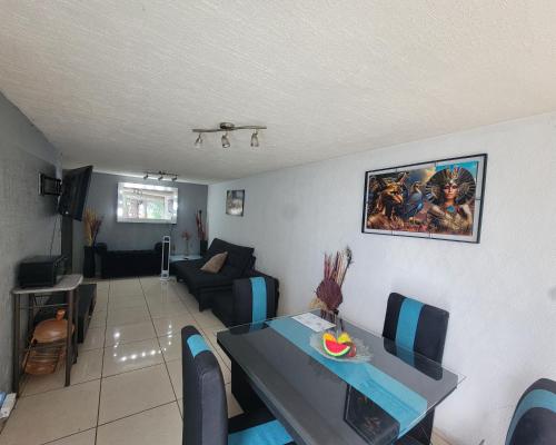 a living room with a table and a couch at Águilas Room 2 camas in Guadalajara